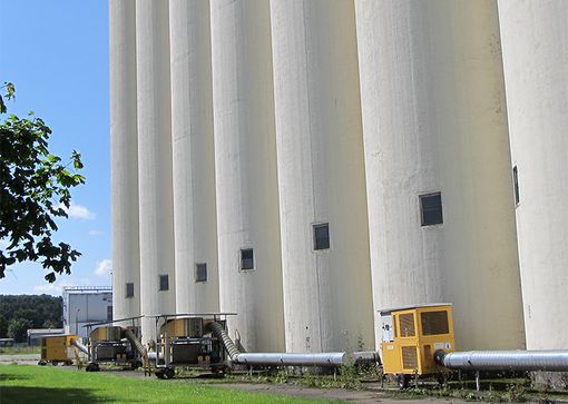 A row of grain cooling units on grain silos